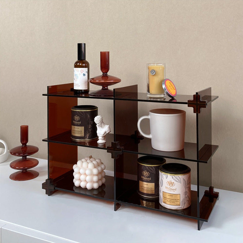 A modern acrylic counter shelf displaying books and decorative items, showcasing its stylish and compact design.