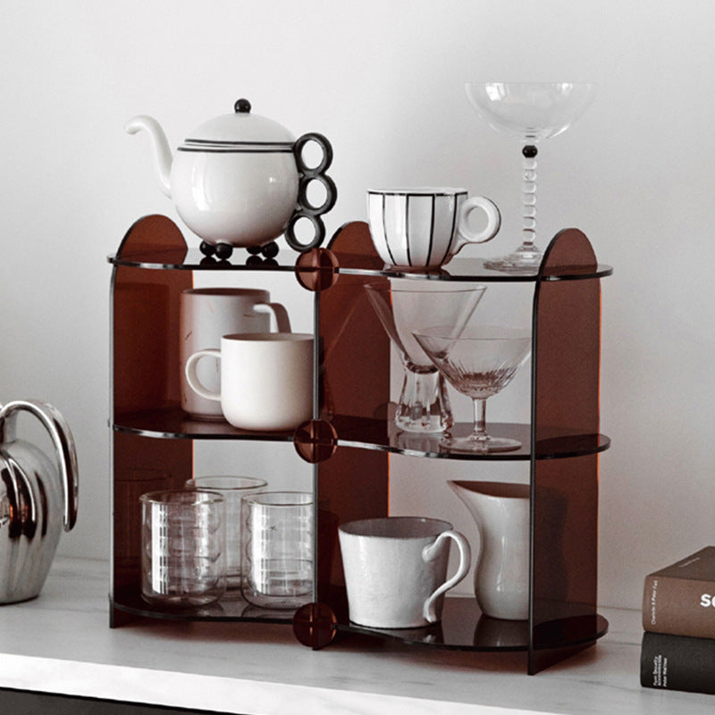 A modern acrylic counter shelf displaying books and decorative items, showcasing its stylish and compact design.