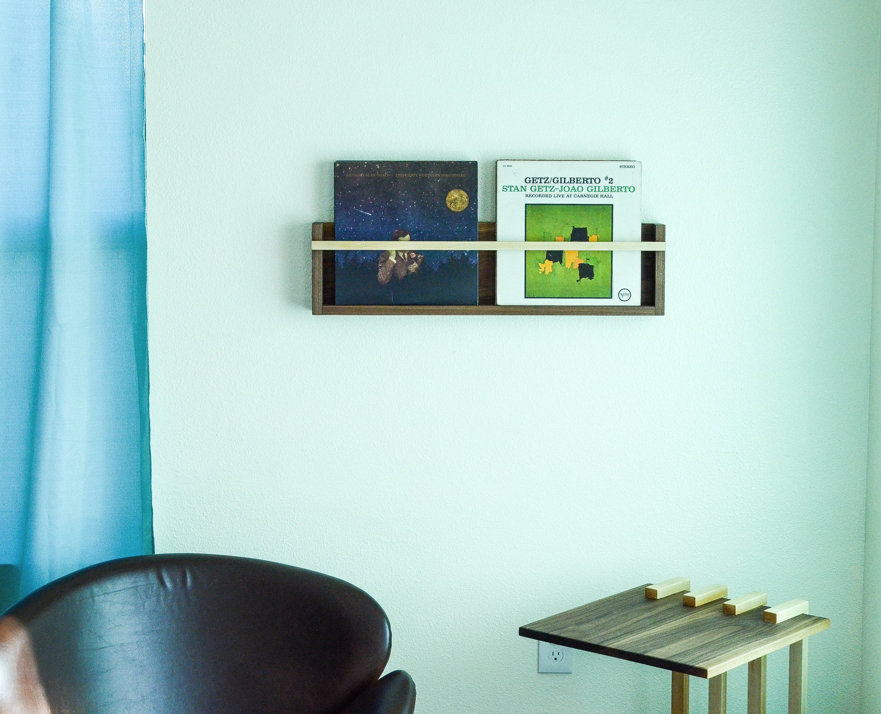 Modern Magazine & Vinyl Wall Rack made from Black Walnut and Maple, showcasing a sleek design for wall-mounted storage.