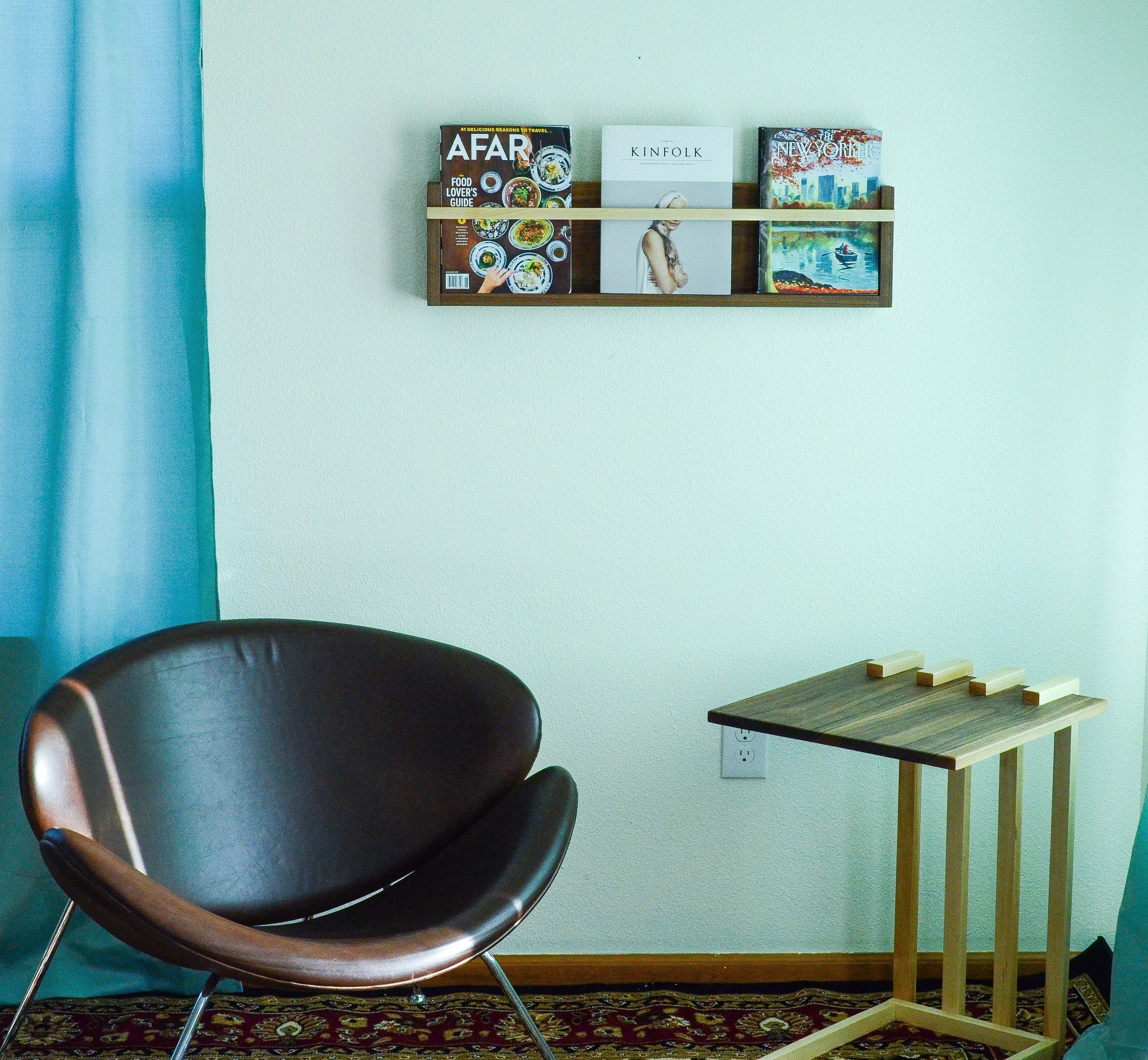 Modern Magazine & Vinyl Wall Rack made from Black Walnut and Maple, showcasing a sleek design for wall-mounted storage.