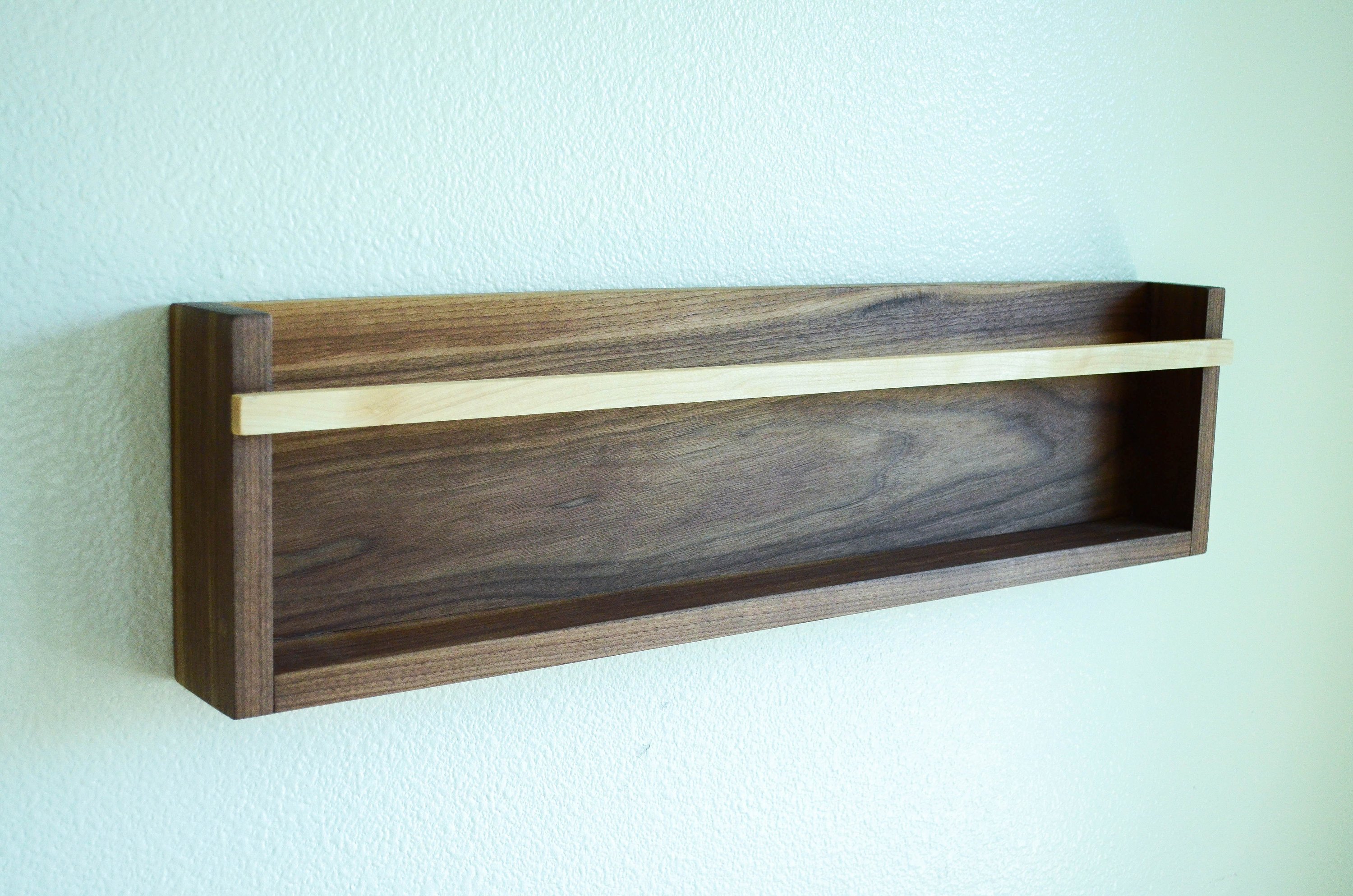 Modern Magazine & Vinyl Wall Rack made from Black Walnut and Maple, showcasing a sleek design for wall-mounted storage.