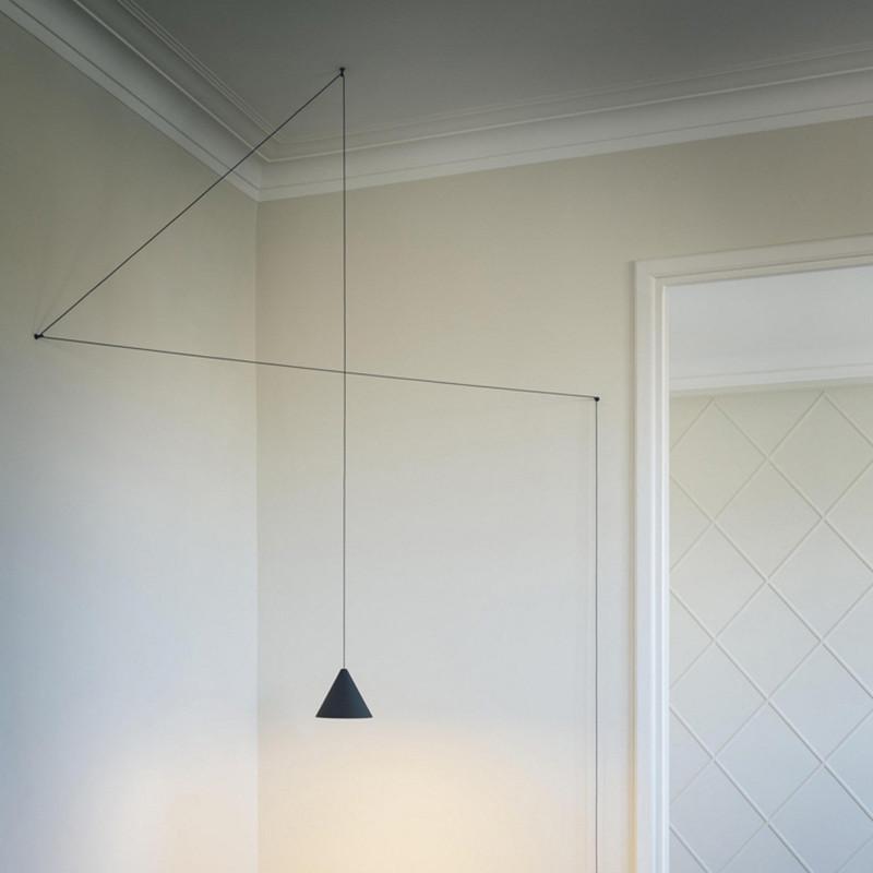 Modern pendant light featuring a black metal cone shape with a long wire, ideal for stylish home and commercial decor.