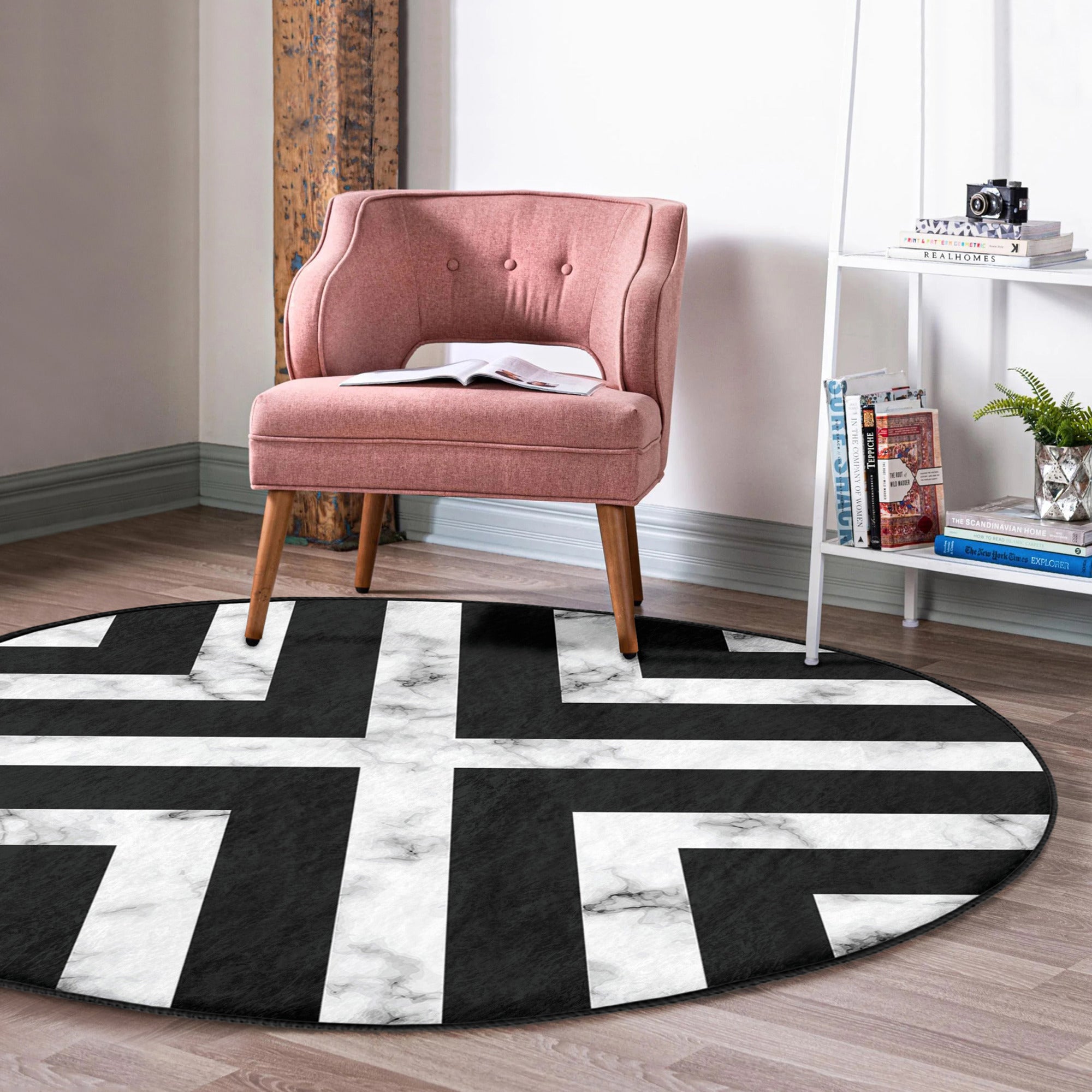 Modern round rug in black and white design, showcasing a soft velvet texture and non-slip backing, perfect for living room decor.