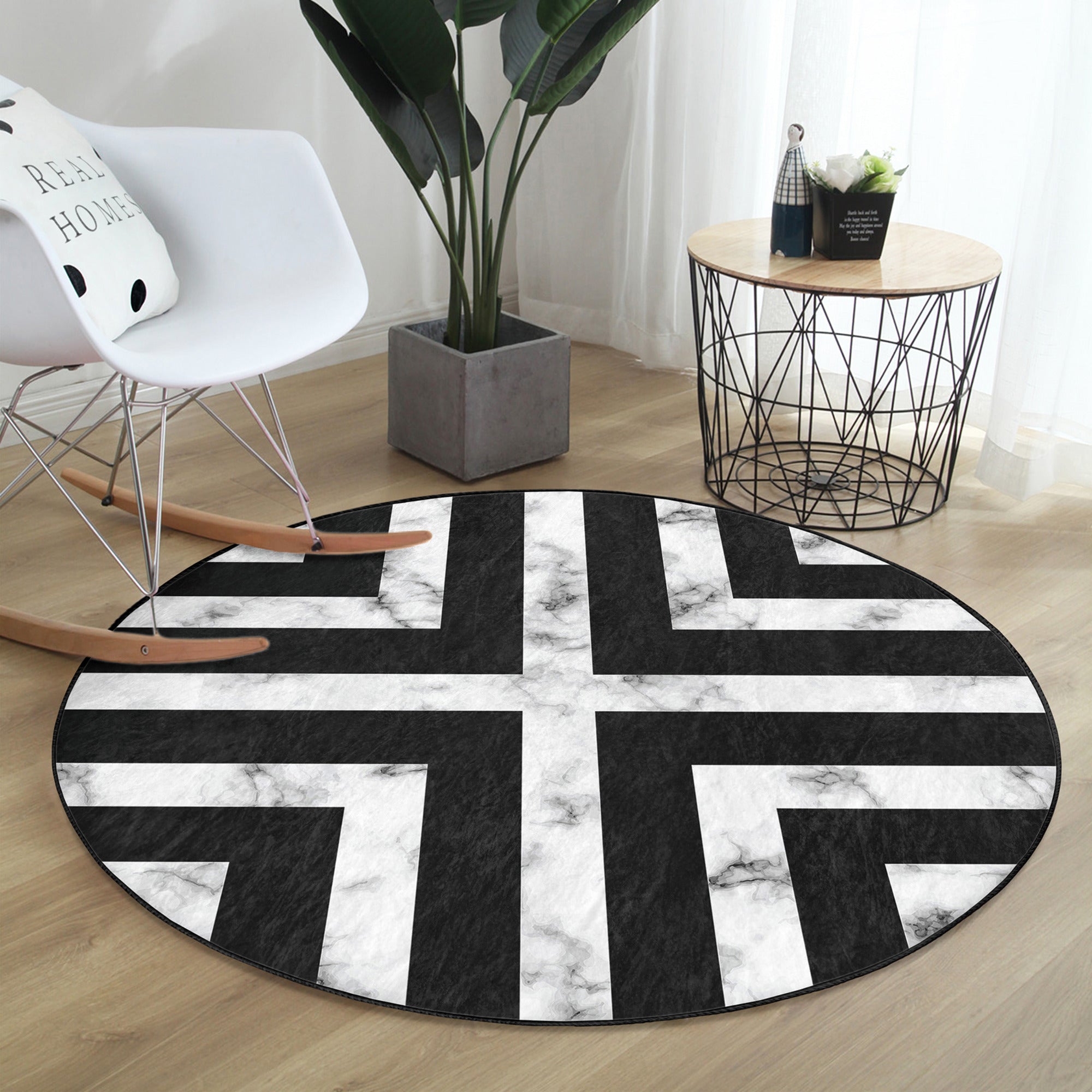 Modern round rug in black and white design, showcasing a soft velvet texture and non-slip backing, perfect for living room decor.