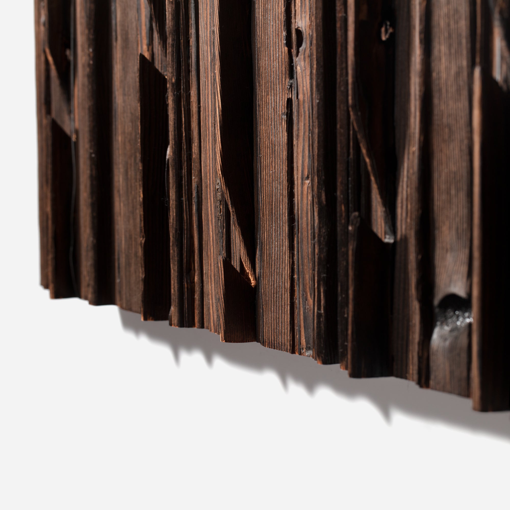 Mr. Hook coat rack featuring unique wood design with brass hooks, showcasing torched black and natural wood finish.