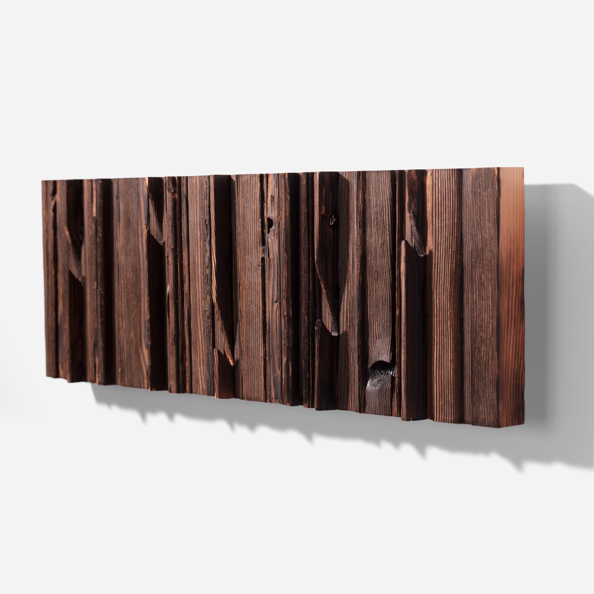 Mr. Hook coat rack featuring unique wood design with brass hooks, showcasing torched black and natural wood finish.