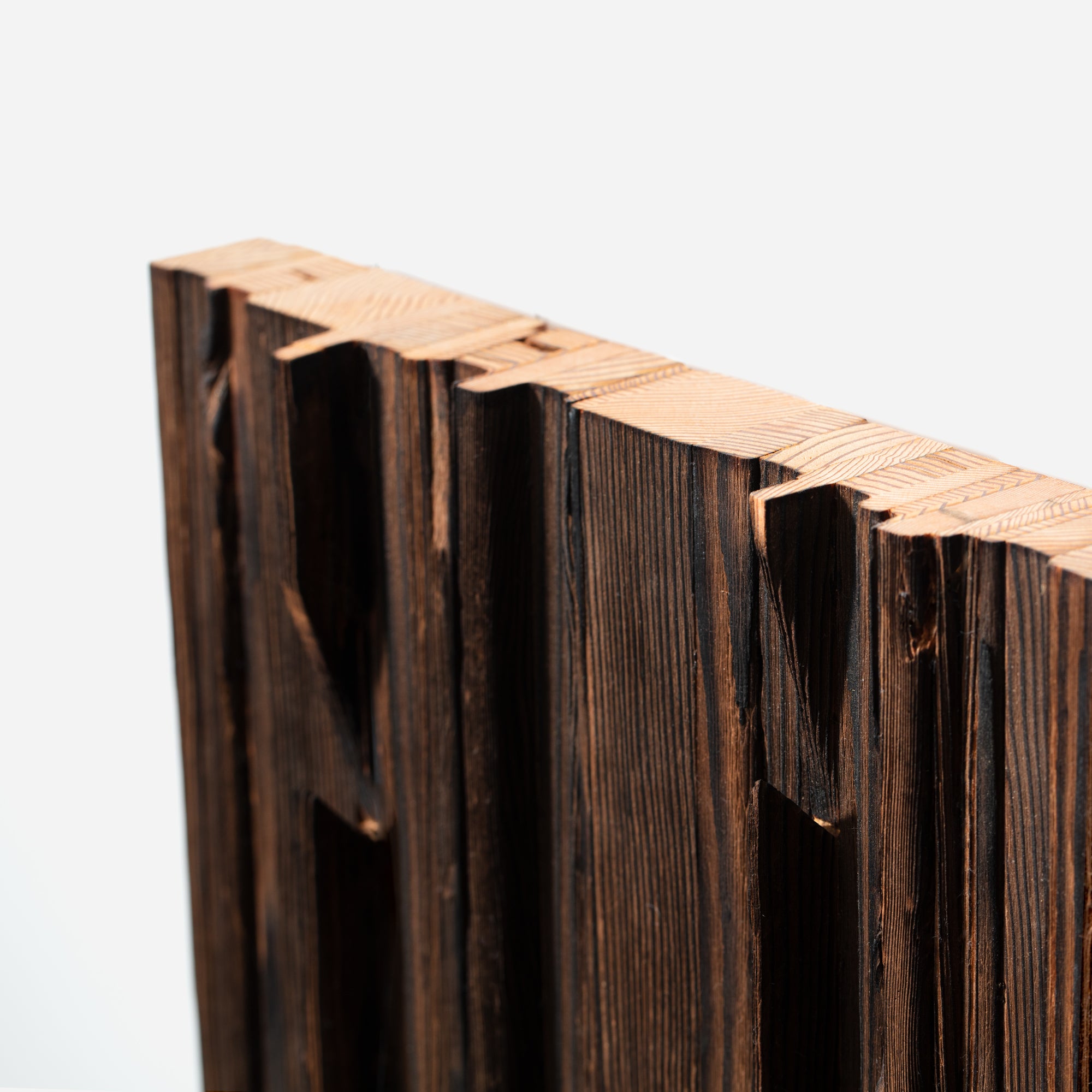 Mr. Hook coat rack featuring unique wood design with brass hooks, showcasing torched black and natural wood finish.