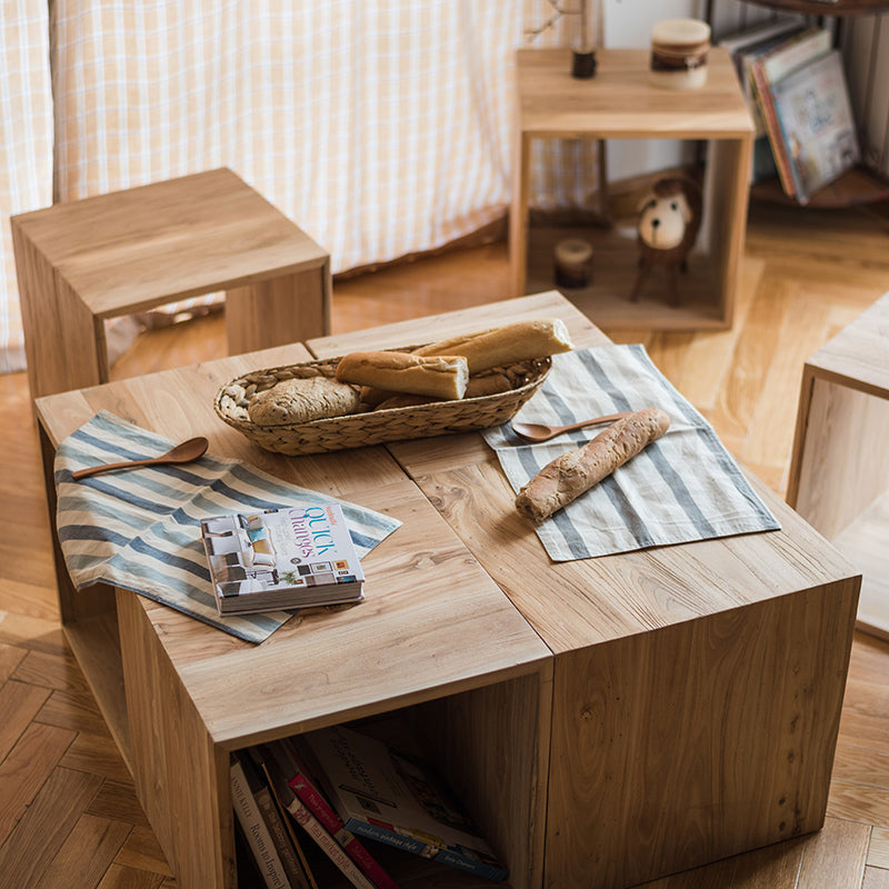 Wooden table with bread and books.