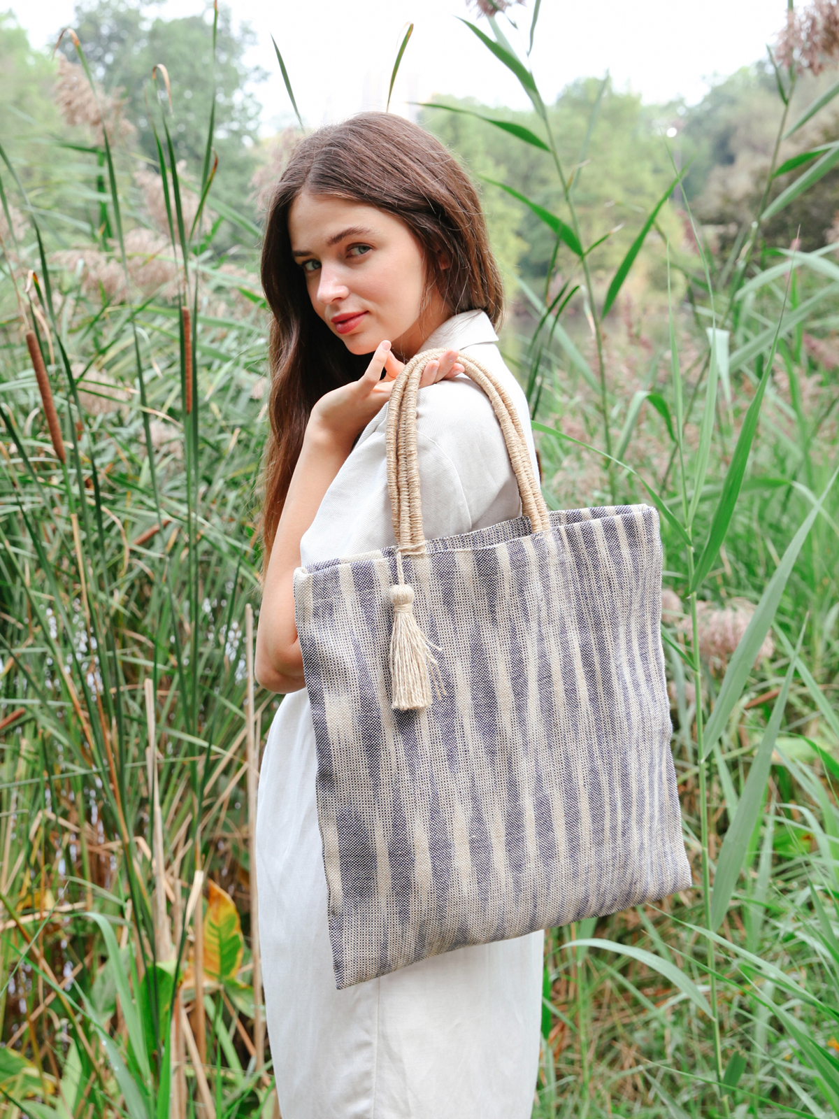 Nadi Jute Tote Bag in Blue, handwoven and naturally dyed, showcasing its spacious design and sturdy handles.