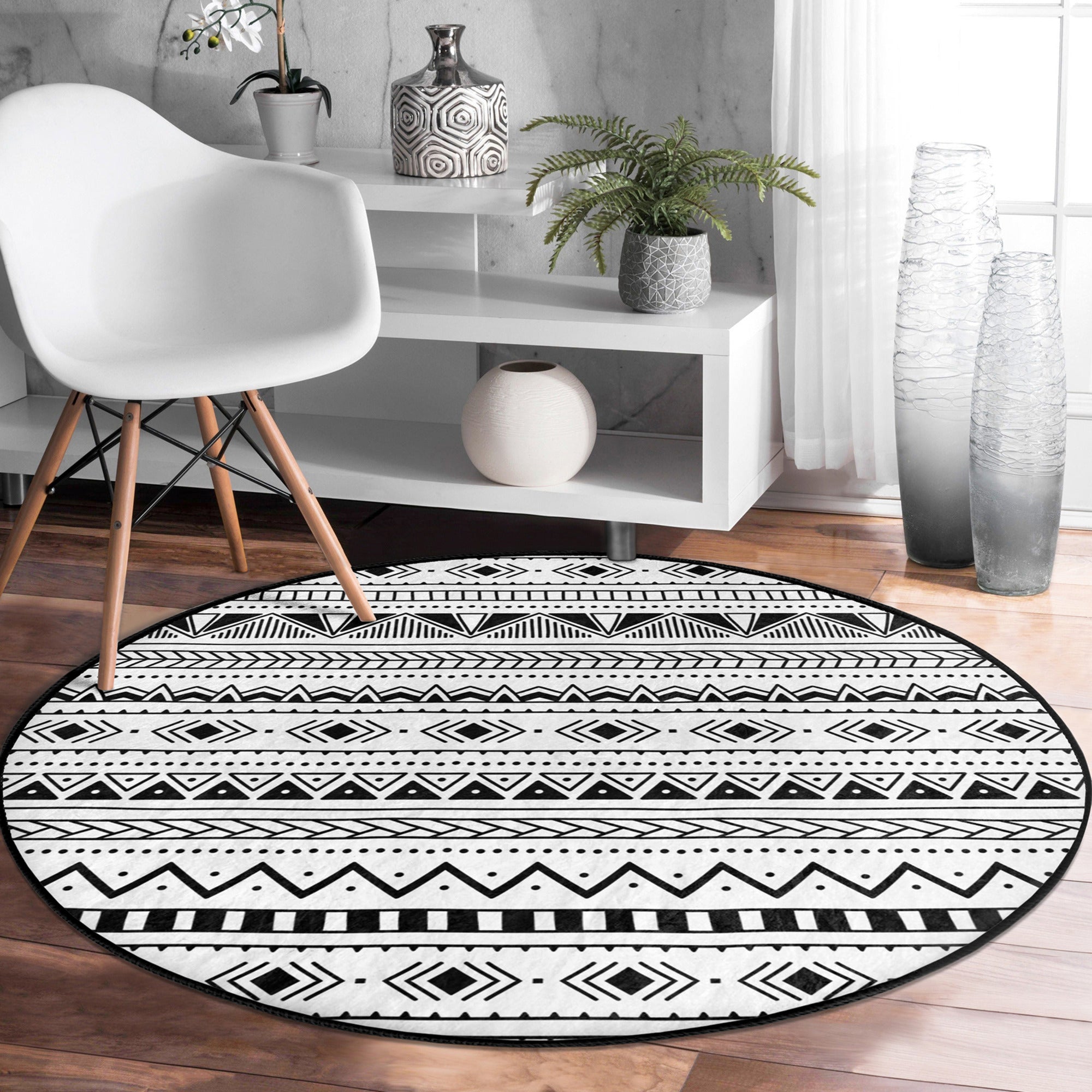 Native Round Rug in black and white, showcasing its soft velvet texture and round shape, perfect for home decor.