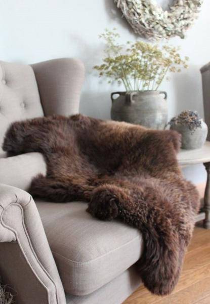 Luxurious Natural Brown Sheepskin rug with long, soft hair, showcasing its unique texture and rich color.