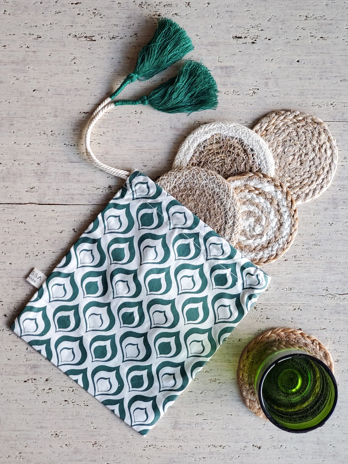 Natural Coaster Gift Set featuring four handmade jute coasters and a green drawstring pouch, showcasing eco-friendly craftsmanship.