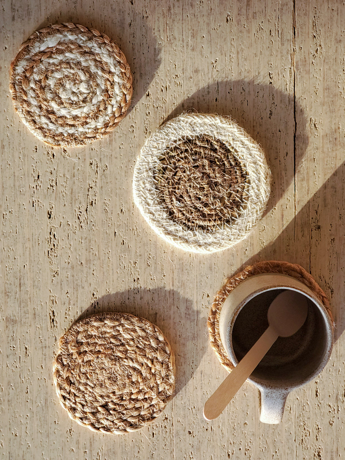 Natural Coaster Gift Set featuring four handmade jute coasters and a green drawstring pouch, showcasing eco-friendly craftsmanship.