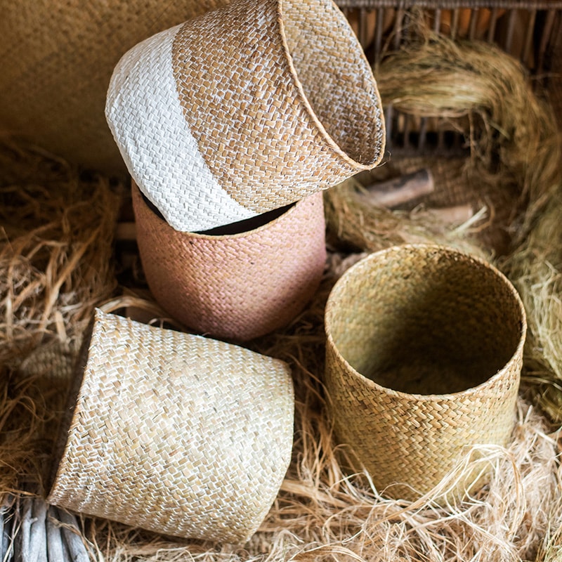 Natural Straw Basket in various colors, showcasing its elegant design and lightweight structure, perfect for home organization.