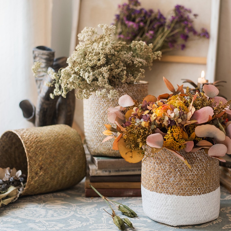 Natural Straw Basket in various colors, showcasing its elegant design and lightweight structure, perfect for home organization.