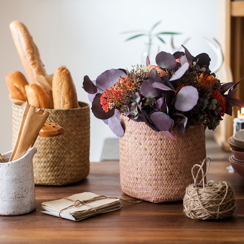 Natural Straw Basket in various colors, showcasing its elegant design and lightweight structure, perfect for home organization.