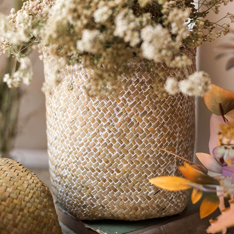 Natural Straw Basket in various colors, showcasing its elegant design and lightweight structure, perfect for home organization.