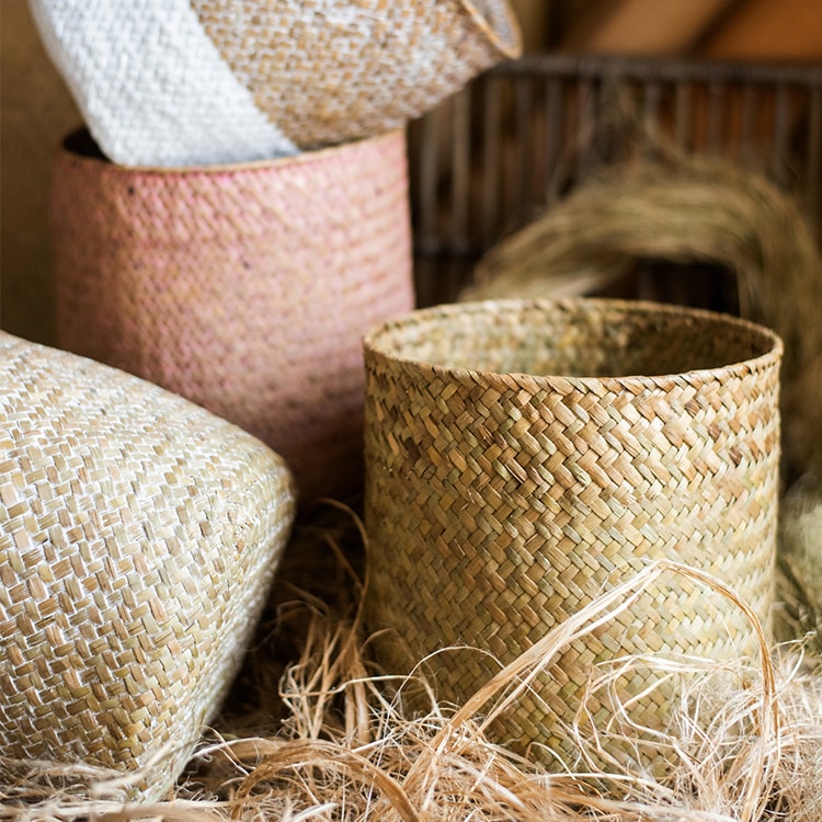 Natural Straw Basket in various colors, showcasing its elegant design and lightweight structure, perfect for home organization.