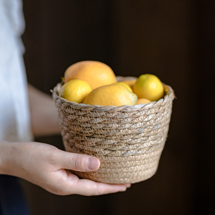 Natural Straw Desktop Flower Basket in khaki/brown color, showcasing its round shape and woven texture, ideal for flowers or desk organization.