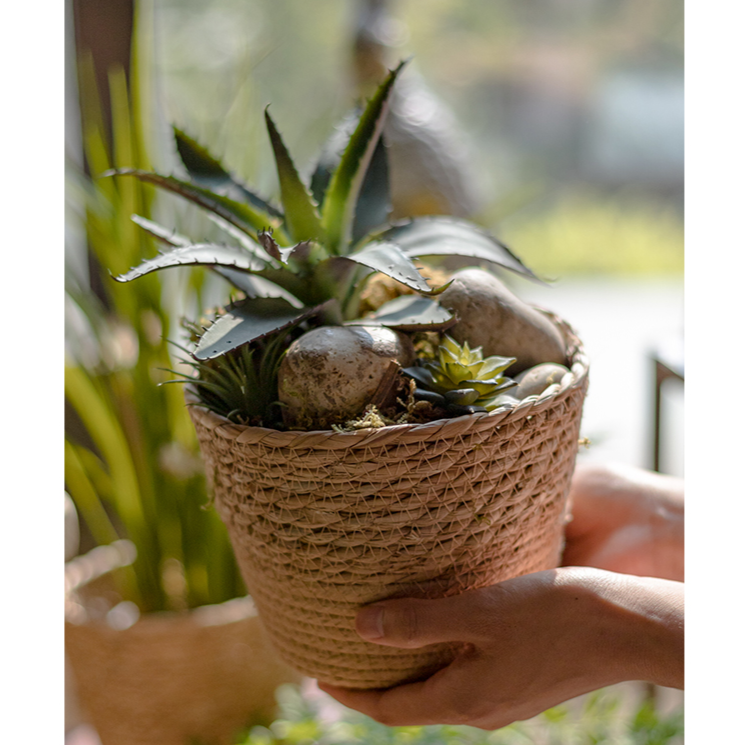 Natural Straw Desktop Flower Basket in khaki/brown color, showcasing its round shape and woven texture, ideal for flowers or desk organization.