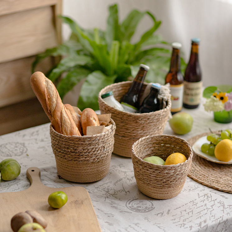 Natural Straw Desktop Flower Basket in khaki/brown color, showcasing its round shape and woven texture, ideal for flowers or desk organization.