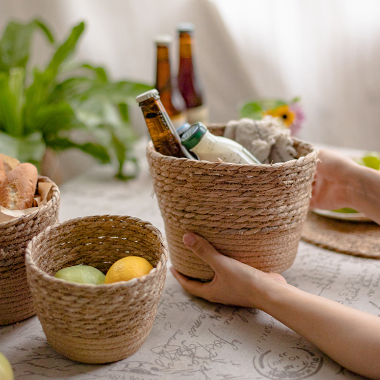 Natural Straw Desktop Flower Basket in khaki/brown color, showcasing its round shape and woven texture, ideal for flowers or desk organization.