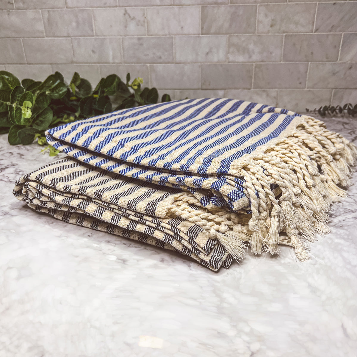 Nautical Towel 180GSM made from 100% Turkish cotton, featuring blue and grey stripes with decorative tassels.