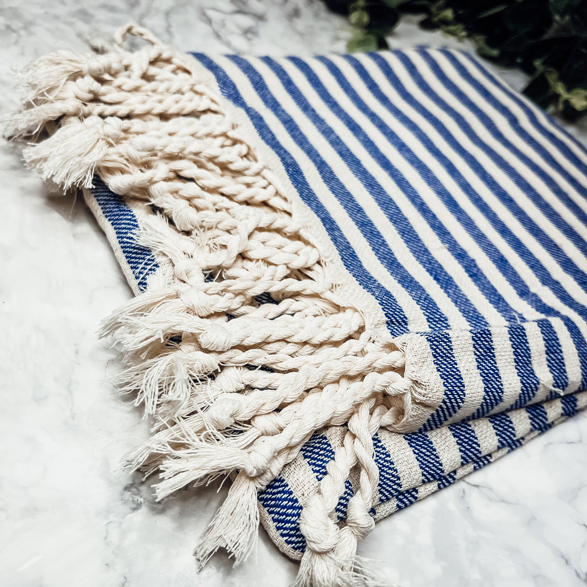 Nautical Towel 180GSM made from 100% Turkish cotton, featuring blue and grey stripes with decorative tassels.