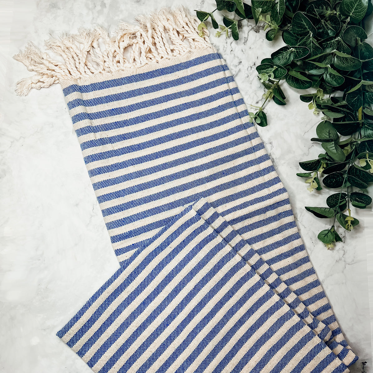 Nautical Towel 180GSM made from 100% Turkish cotton, featuring blue and grey stripes with decorative tassels.