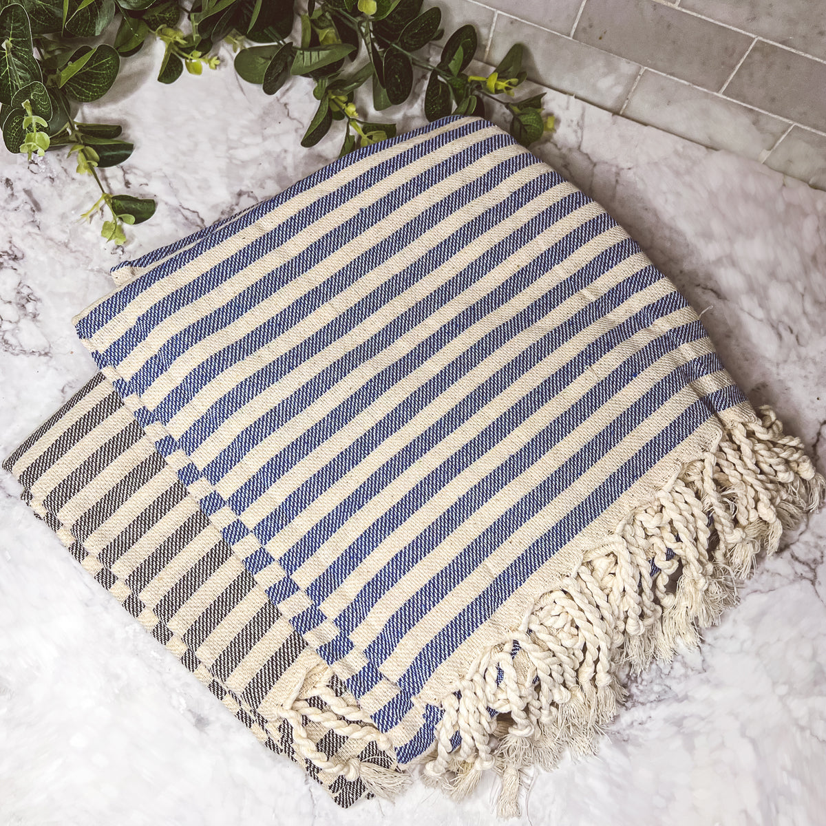 Nautical Towel 180GSM made from 100% Turkish cotton, featuring blue and grey stripes with decorative tassels.