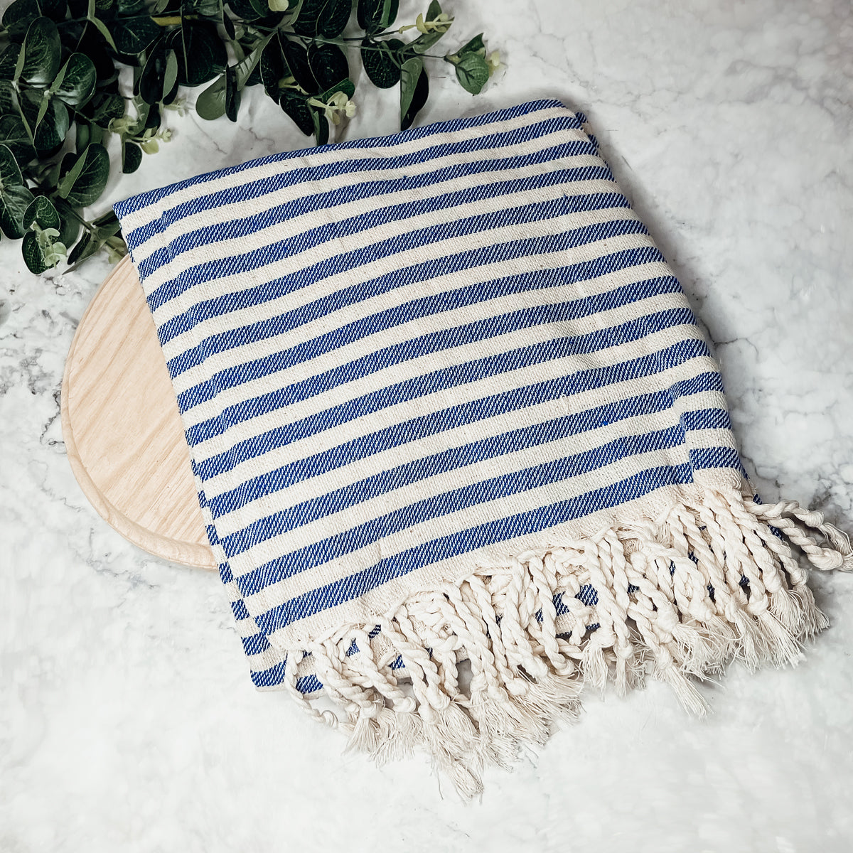 Nautical Towel 180GSM made from 100% Turkish cotton, featuring blue and grey stripes with decorative tassels.