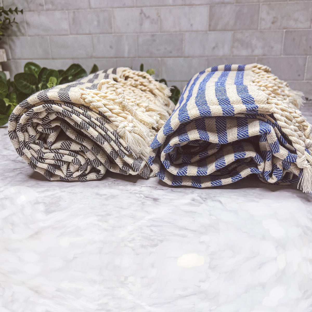 Nautical Towel 180GSM made from 100% Turkish cotton, featuring blue and grey stripes with decorative tassels.