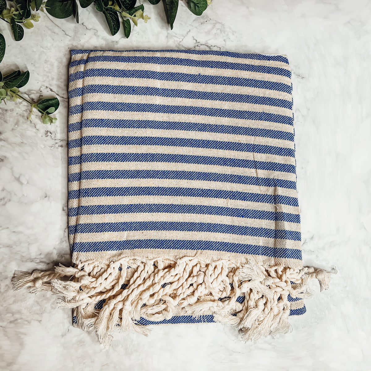 Nautical Towel 180GSM made from 100% Turkish cotton, featuring blue and grey stripes with decorative tassels.