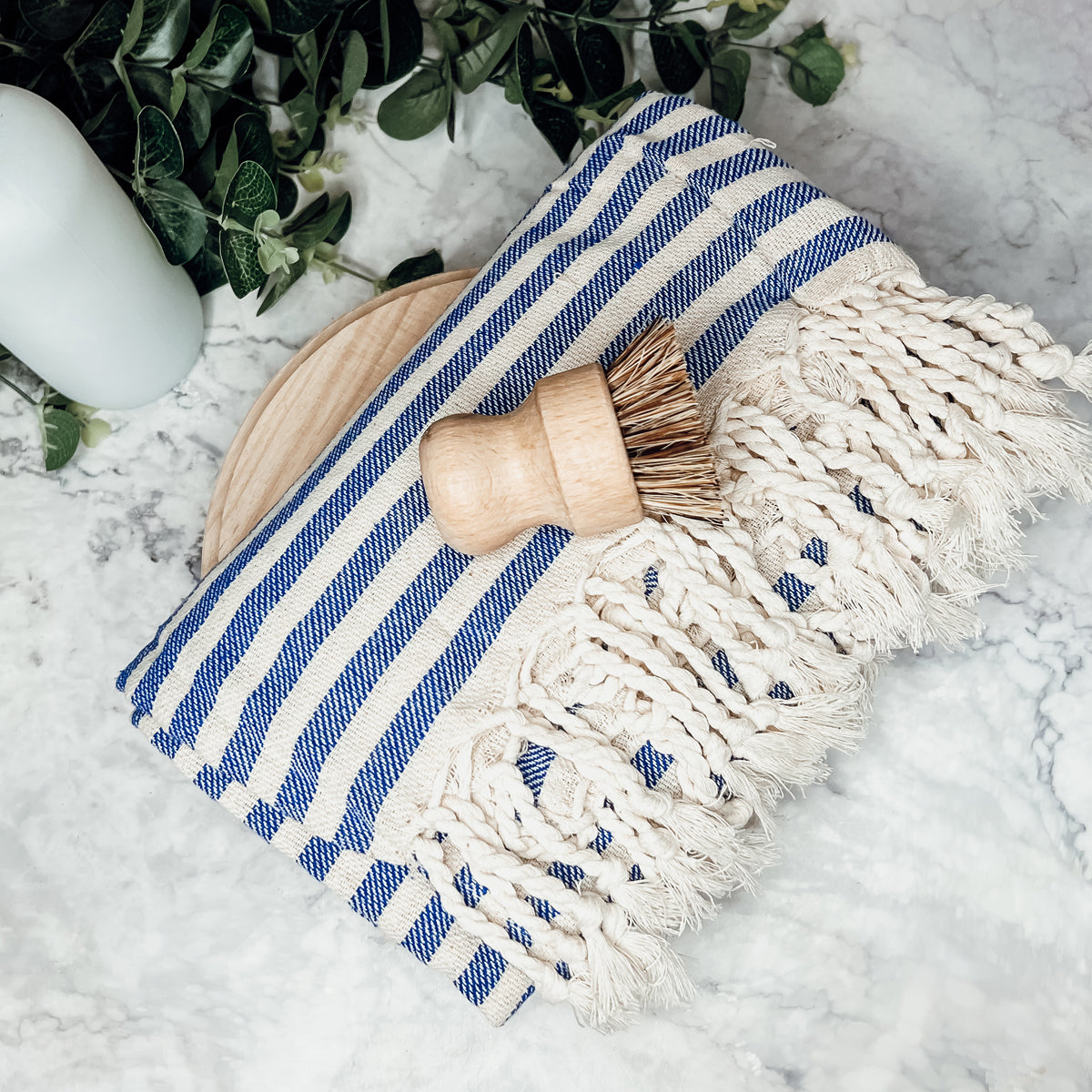 Nautical Towel 180GSM made from 100% Turkish cotton, featuring blue and grey stripes with decorative tassels.