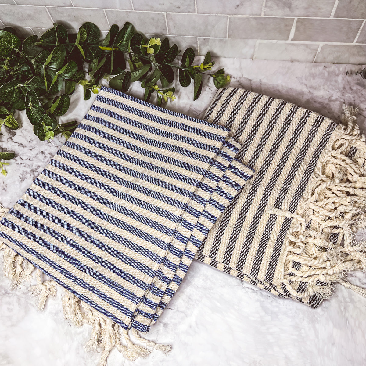 Nautical Towel 180GSM made from 100% Turkish cotton, featuring blue and grey stripes with decorative tassels.