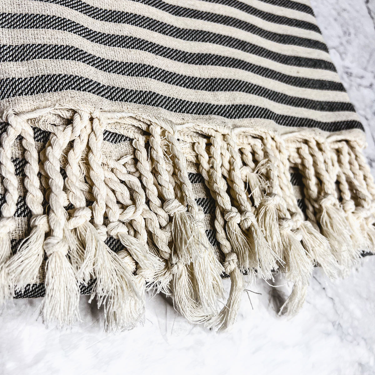 Nautical Towel 180GSM made from 100% Turkish cotton, featuring blue and grey stripes with decorative tassels.