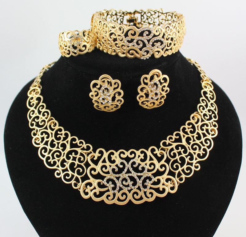 Elegant African jewelry set featuring a necklace, bracelet, earrings, and rings, crafted with 18K gold plating and sparkling crystals.