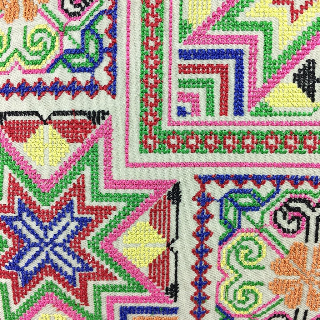 Colorful Needlepoint Tassel Pillow Cover handcrafted by Hmong artisans, featuring intricate embroidery and a vibrant design.