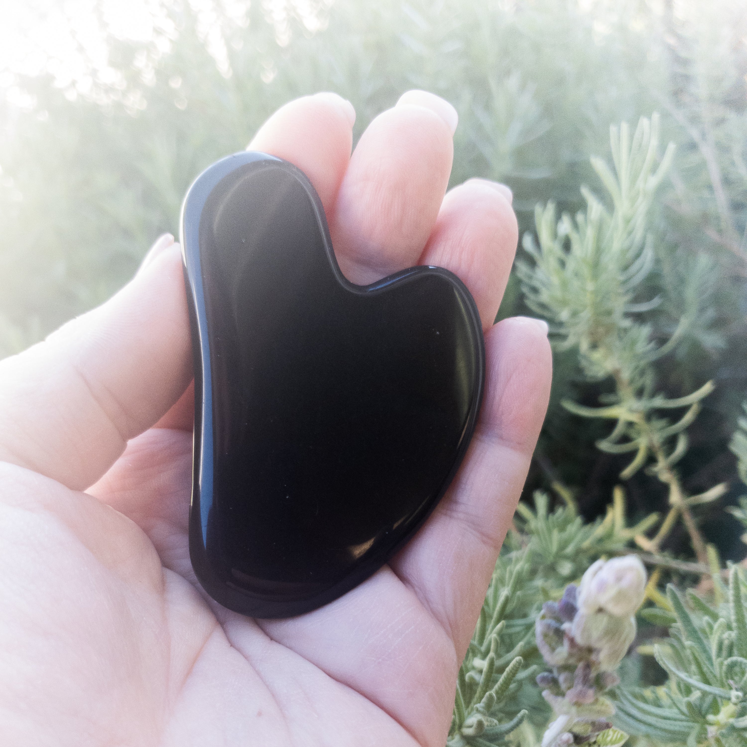 NEW Black Obsidian Gua Sha Massage Tool, a smooth, dark stone tool designed for facial and body massage.