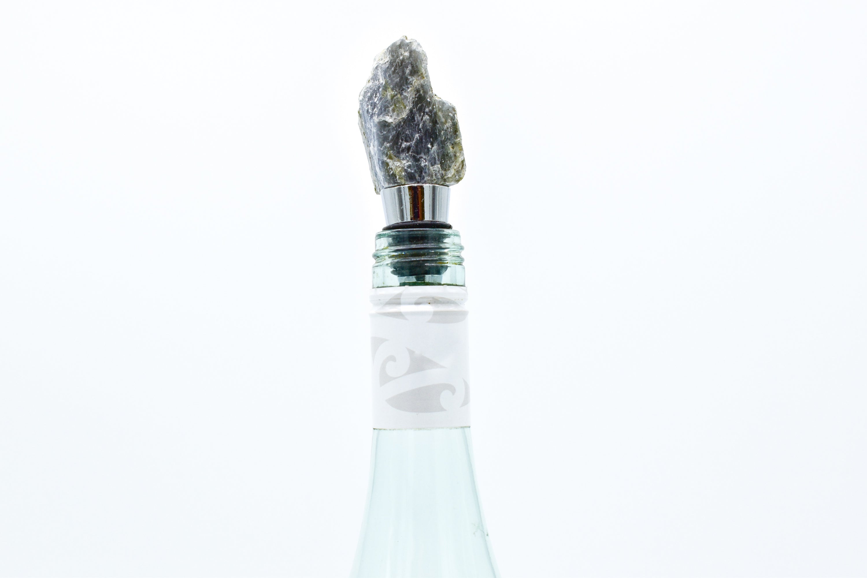 A collection of unique natural stone wine bottle stoppers made from Rose Quartz, Amazonite, Apatite, Amethyst, and Labradorite with stainless steel bases.