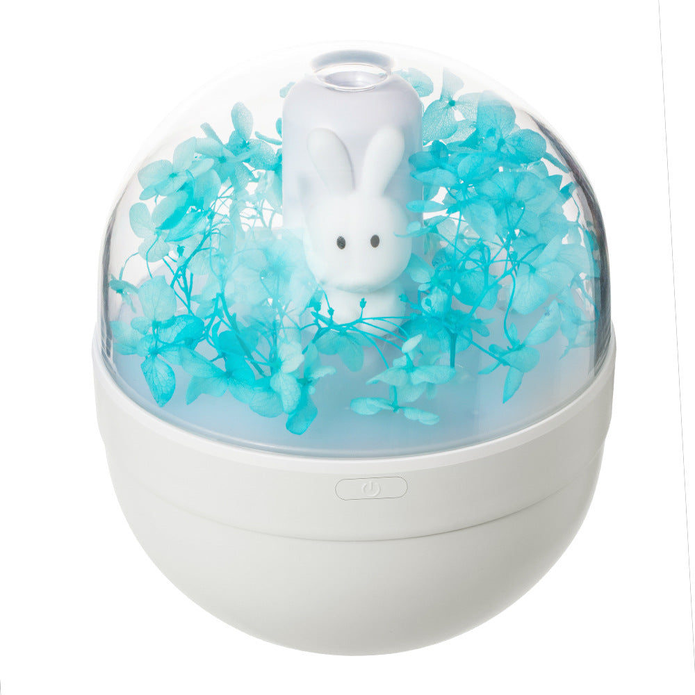 A cute rabbit-shaped humidifier in white and pink, designed for desktop use, showcasing its compact size and USB charging feature.