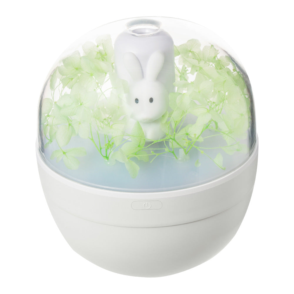 A cute rabbit-shaped humidifier in white and pink, designed for desktop use, showcasing its compact size and USB charging feature.