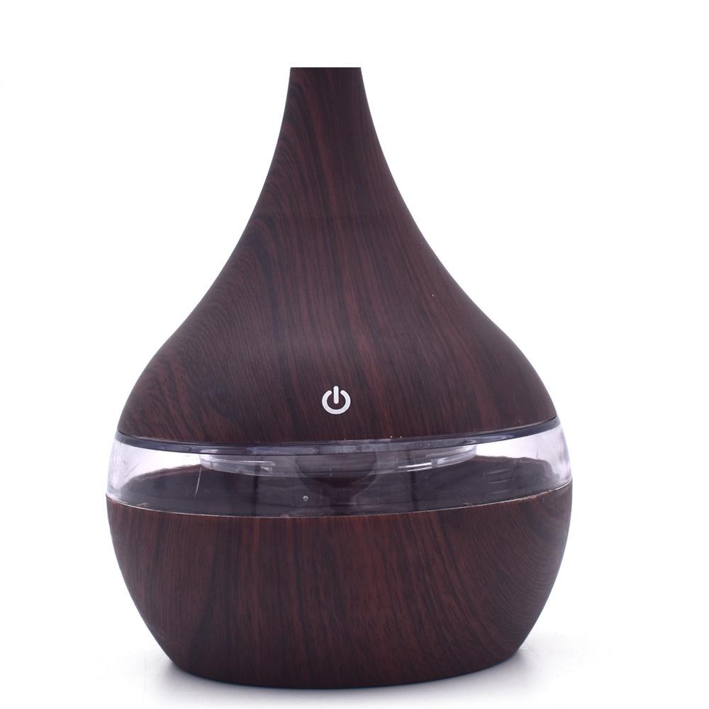 New USB Electric Aroma Diffuser in wood finish, showcasing its elegant design and functionality for essential oil diffusion.