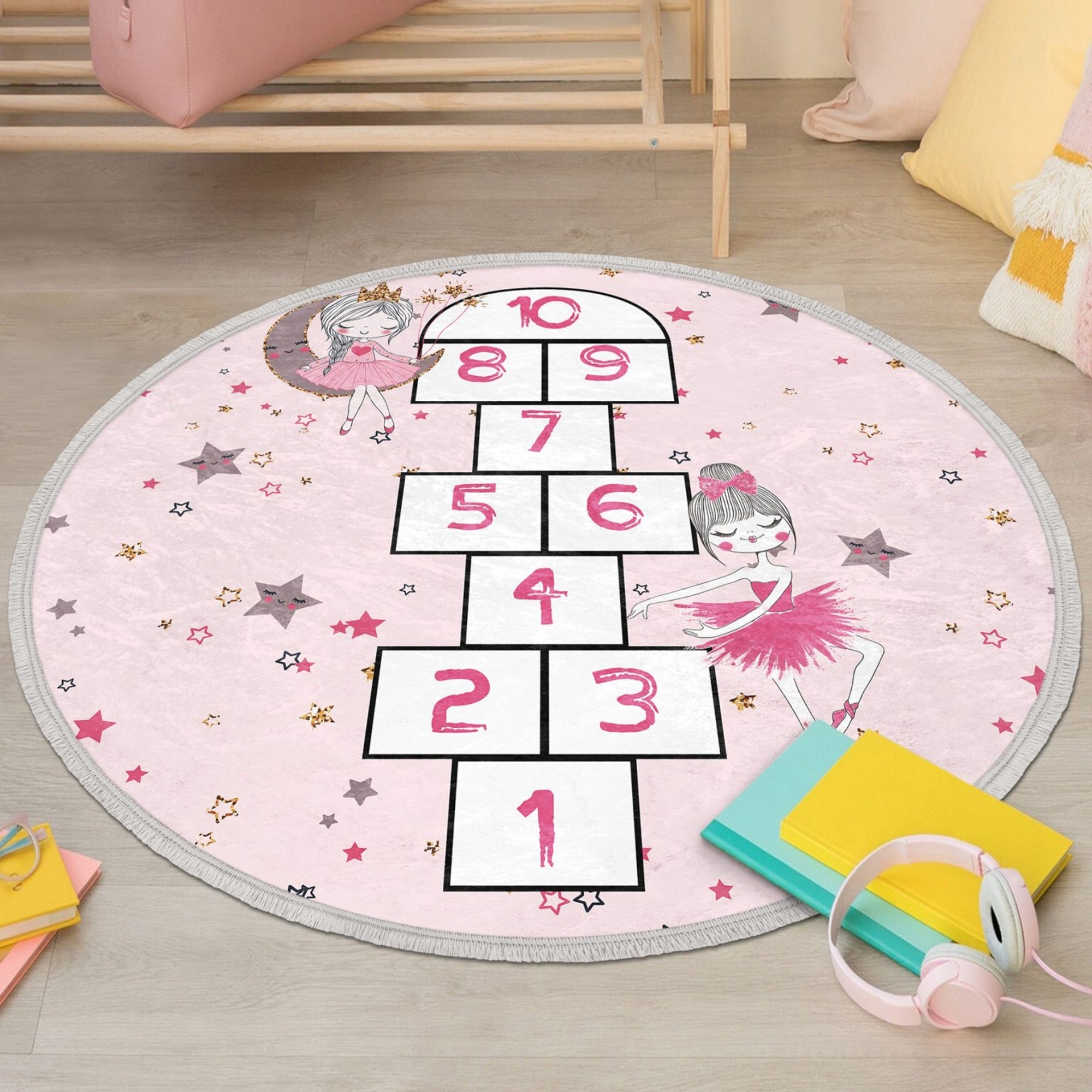 A vibrant pink circle rug featuring playful numbers, perfect for a child's room or nursery, showcasing its soft texture and non-slip backing.