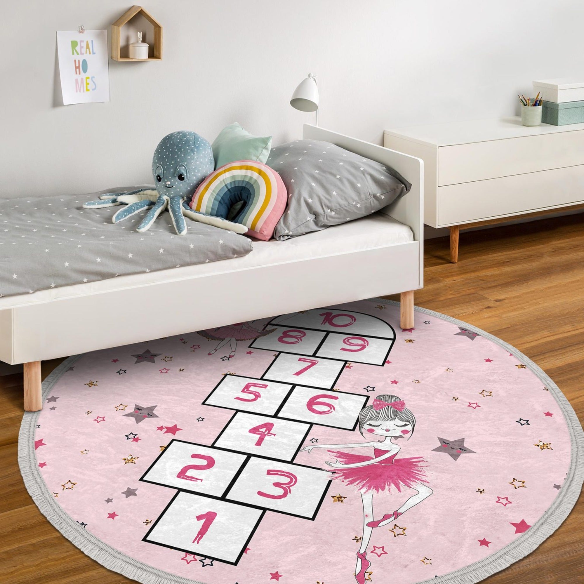 A vibrant pink circle rug featuring playful numbers, perfect for a child's room or nursery, showcasing its soft texture and non-slip backing.