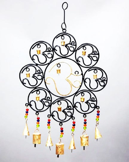 A colorful OM Brass Bells wall hanging featuring vibrant glass beads, showcasing intricate craftsmanship and a positive vibe.