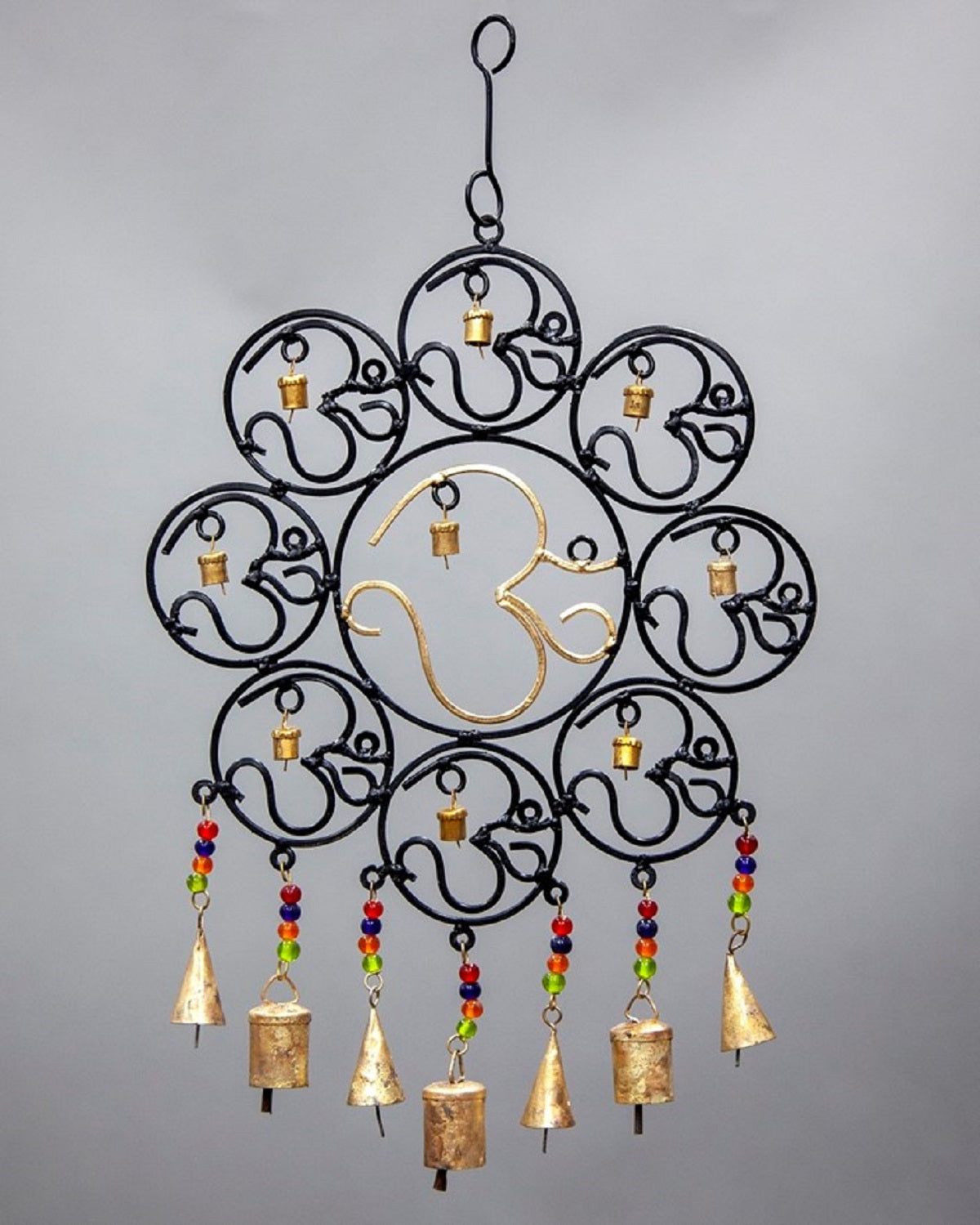 A colorful OM Brass Bells wall hanging featuring vibrant glass beads, showcasing intricate craftsmanship and a positive vibe.