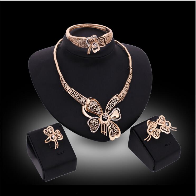 Elegant hollow butterfly jewelry set featuring a white gemstone necklace, bracelet, earrings, and rings, beautifully crafted in 18K gold plating.