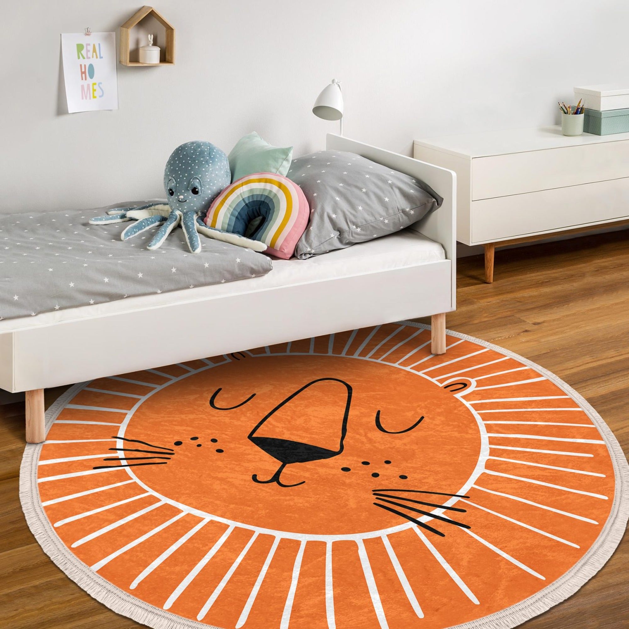 Orange round rug featuring a playful lion print, perfect for kids' rooms and nurseries.