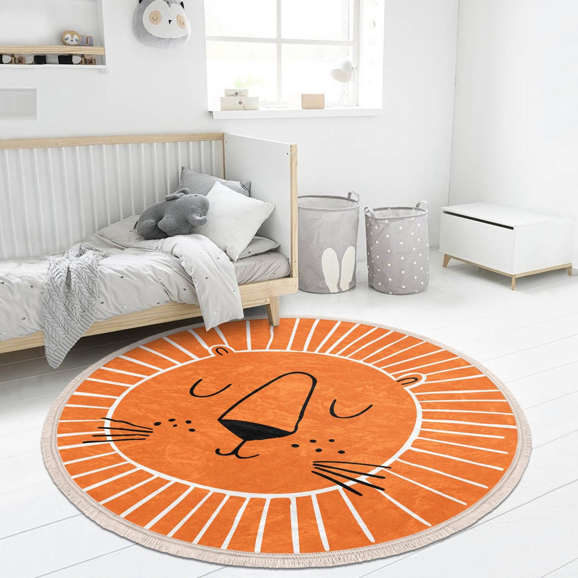 Orange round rug featuring a playful lion print, perfect for kids' rooms and nurseries.